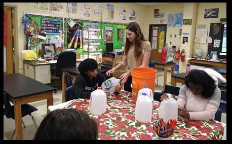 RHS students making rain barrels using recycled materials